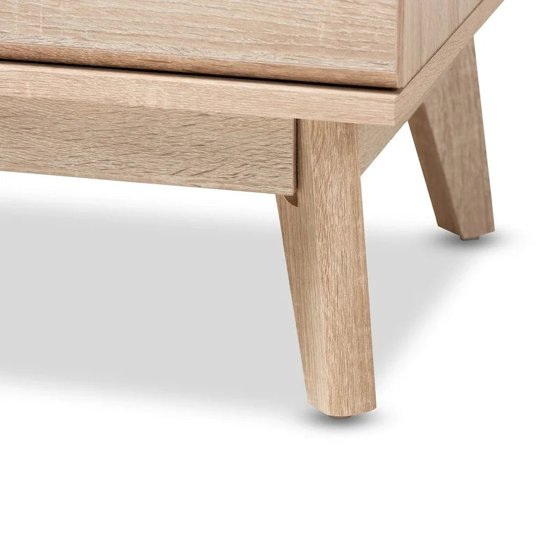 Features include five drawers, a mid-century modern style, a two-tone design, and tapered legs.