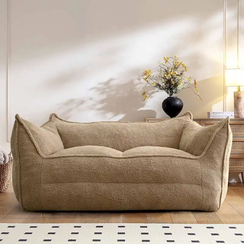 A sectional sofa with a light brown, lambskin-like texture.