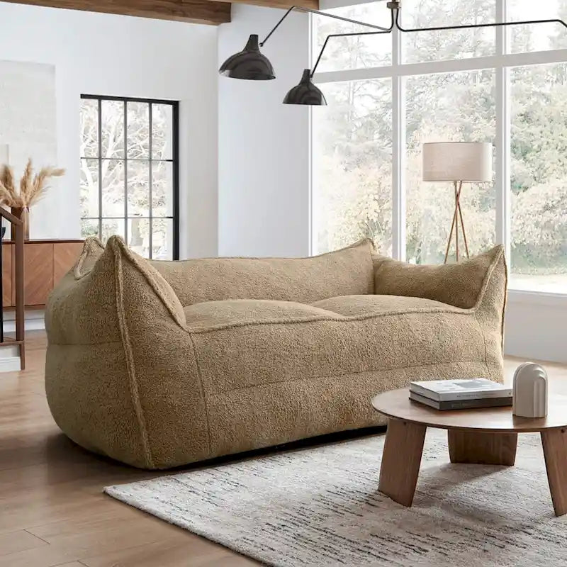 A sectional sofa with a light brown, lambskin-like texture.
