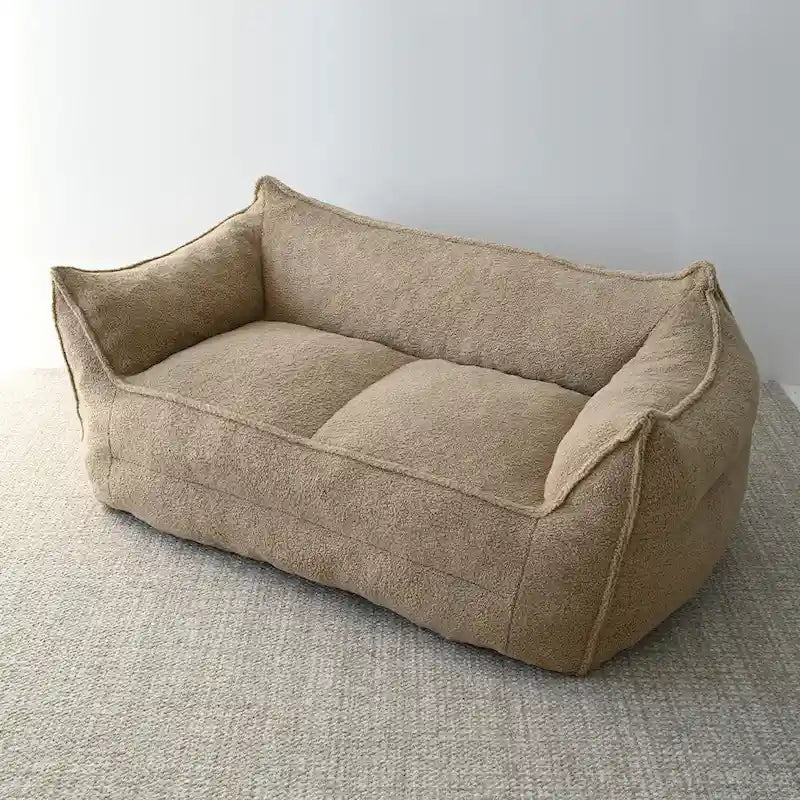 A sectional sofa with a light brown, lambskin-like texture.