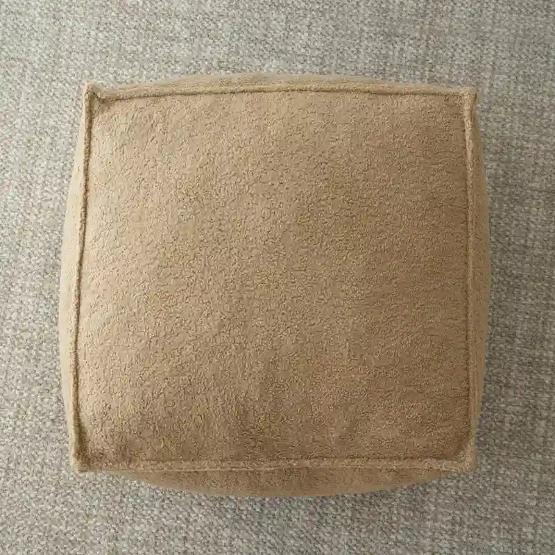 A sectional sofa with a light brown, lambskin-like texture.